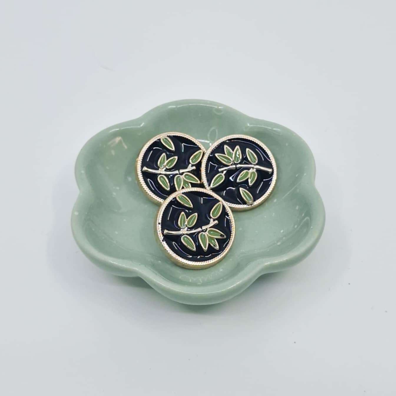 Knapp med laurbærkvist